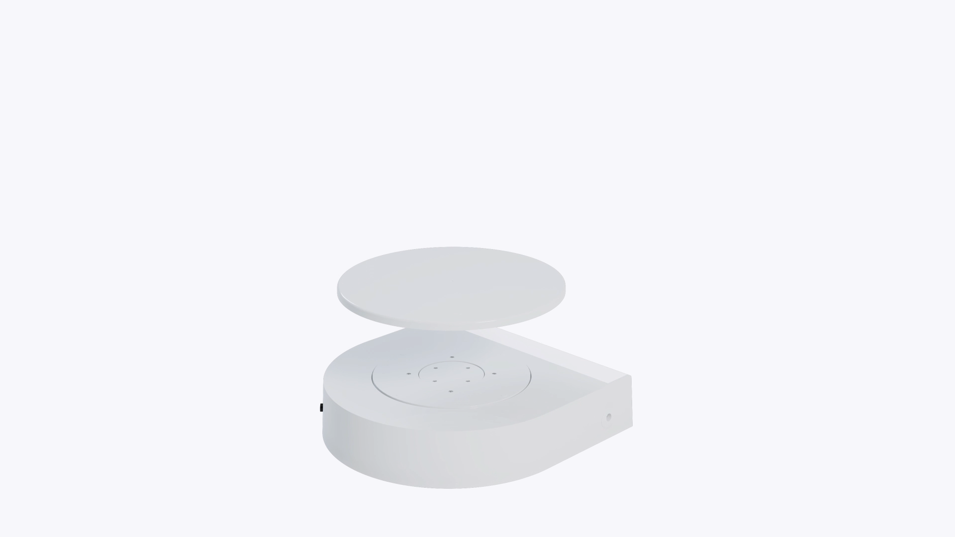A hand lifting the white disc off the GemLightbox Turntable.